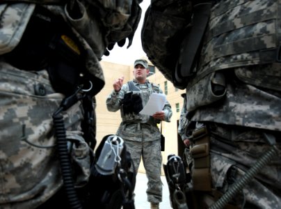 Air Guardsman discusses transportation information with a security detail inside the U.S. Embassy compound in Baghdad