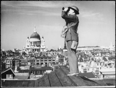 Aircraft spotter on the roof of a building in London. St. Paul's Cathedral is in the background - NARA - 541899