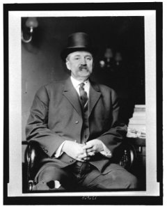 Albert Baird Cummins, Senator from Iowa, three-quarter length portrait, seated, wearing hat, holding cigar LCCN2007684753