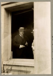 Attorney General Alexander Mitchell Palmer, half-length portrait, standing, facing slightly right; seen through the window of his home at 2132 R. Street, N.W., Washington, D.C., after it was LCCN2015647040