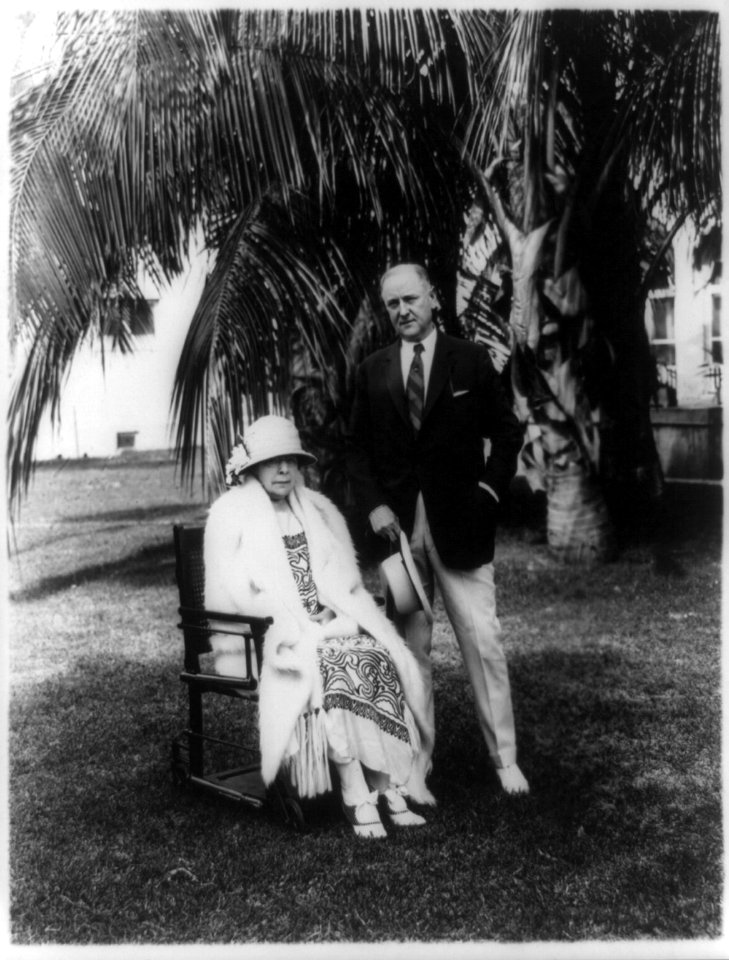 Atty. Gen. Harry Micajah Daugherty, full-length portrait, standing next to wife, under palm tree LCCN90707421