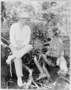 Author Frederick O'Brien and half nude Samoan girl, seated and facing each other, in the South Pacific LCCN2003653915