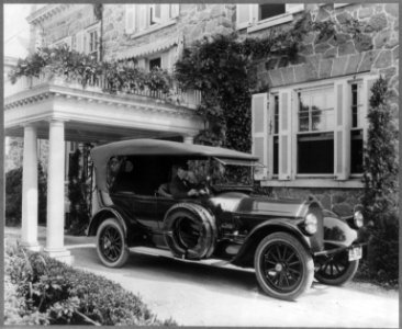 Automobile owned by Mrs. Charles W. Richardson in driveway with driver at the wheel, Washington, D.C. LCCN2001698382