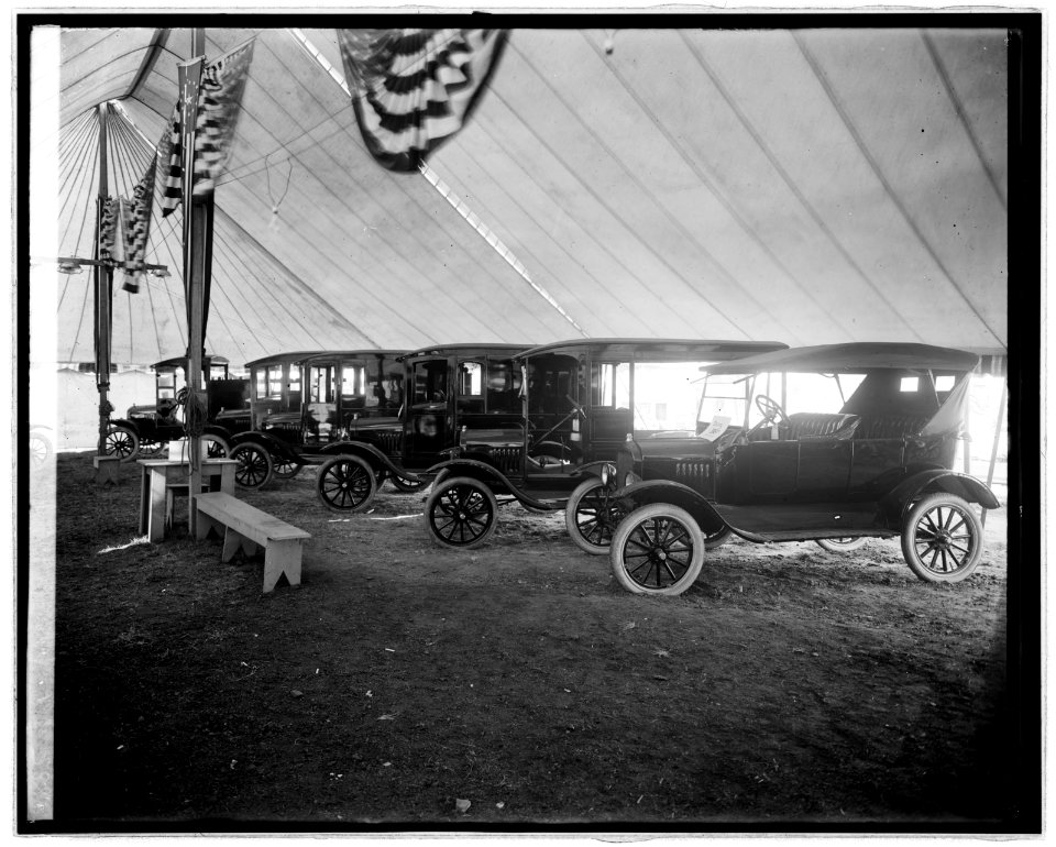 Automobiles on display in tent LCCN2016824037