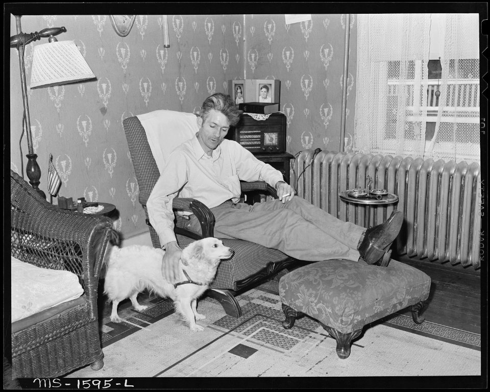B. B. Barksdale, section foreman in mine, in the living room of his six room house. The house has running water and... - NARA - 540870