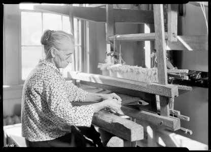 Aunt Lizzie Reagan, at the Pi Beta Phi School, Gatlinburg, Tennessee, weaving old-fashioned jean. Very few can weave... - NARA - 532763 photo