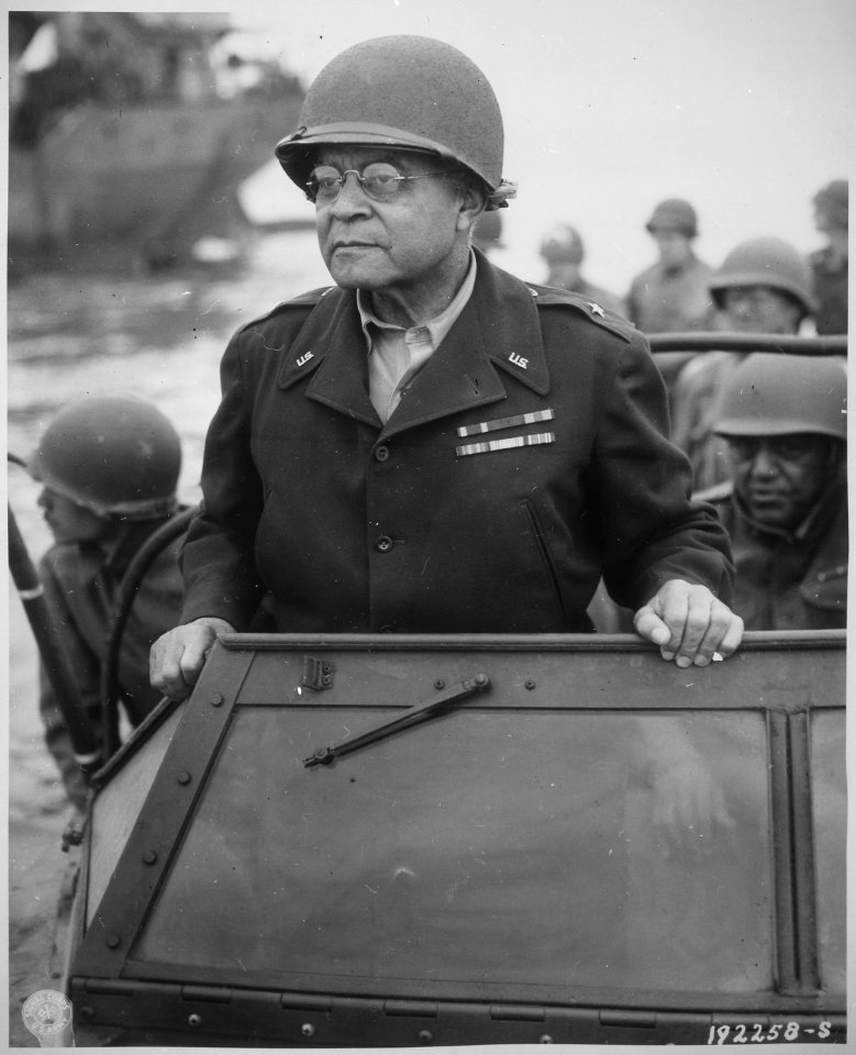 Brig. Gen. Benjamin O. Davis watches a Signal Corps crew erecting poles, somewhere in France., 08-08-1944 - NARA - 531201