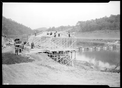 Constructing the temporary warehouse near west end of the heavy duty bridge at the site of Norris Dam on the Clinch... - NARA - 532710