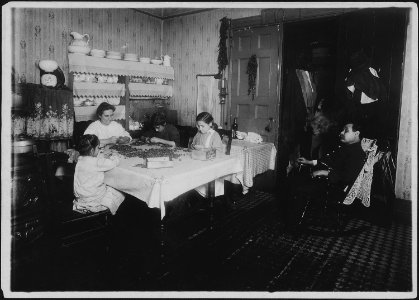 Everybody works but..... A common scene in the tenements. Father sits around. Sometimes I make $9, sometimes 10 a... - NARA - 523491 photo