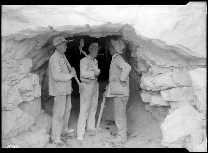 Foreman Clark and two of the shaftmen, Arthur Roberts and Sam Mynatt, at the mouth of the test tunnel at Norris Dam... - NARA - 532663
