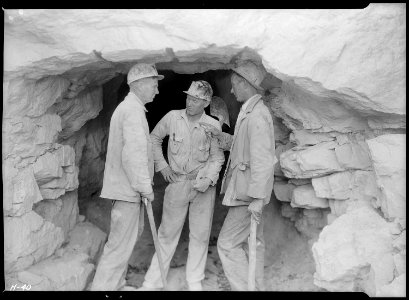 Foreman Clark and two of the shaftmen, Arthur Roberts and Sam Mynatt, at the mouth of the test tunnel at Norris Dam... - NARA - 532664 photo