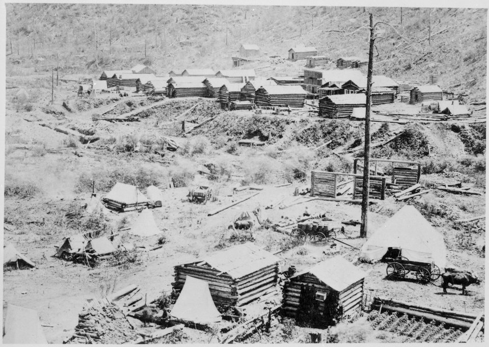 Gayville in Deadwood Gulch, Black Hills (Dak. Terr.), 1876. Log cabins under construction at the foot of a hillside - NARA - 531114