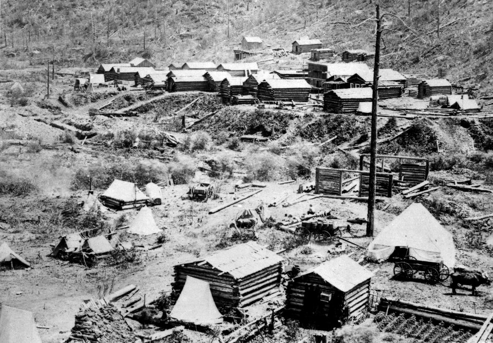 Gayville in Deadwood Gulch, Black Hills (Dak. Terr.), 1876. Log cabins under construction at the foot of a hillside - NARA - 531114
