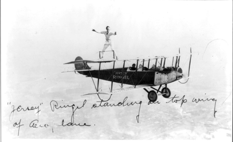 Jersey Ringel standing on top wing of aeroplane LCCN2012646314