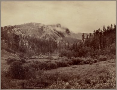 Harney's Peak. Just after a storm. Part of Peak cut off by vaper (sic) but the statuary man in plain view. Photo from west side LCCN99613936