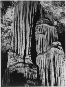 Large stalagmite and stalactite formations in the King's Chamber, detail, Carlsbad Caverns National Park, New Mexico. - NARA - 520044