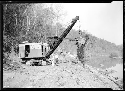 Making the dirt fly at Norris Dam site. A power shovel working on the roadway at the Dam. - NARA - 532694 photo
