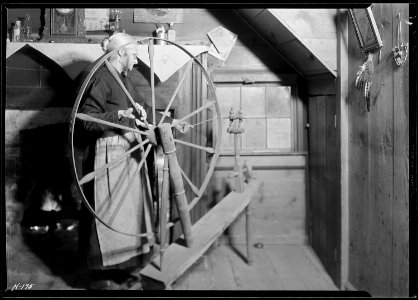 Mrs. Jacob Stooksbury, Loyston, Tennessee, at her spinning wheel. - NARA - 532792 photo