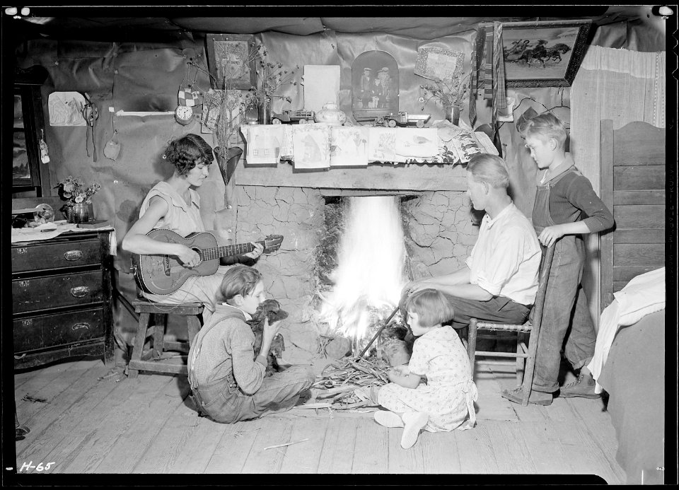 The Glandon family around the fireplace in their home at Bridges Chapel near Loydston(sic), Tennessee. Glandon's... - NARA - 532689
