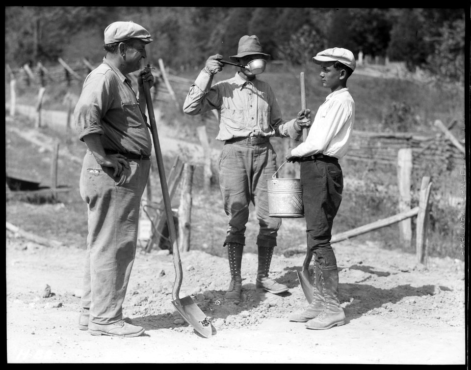 Water boy and two workers on the roadway to Norris Dam site. - NARA - 532704