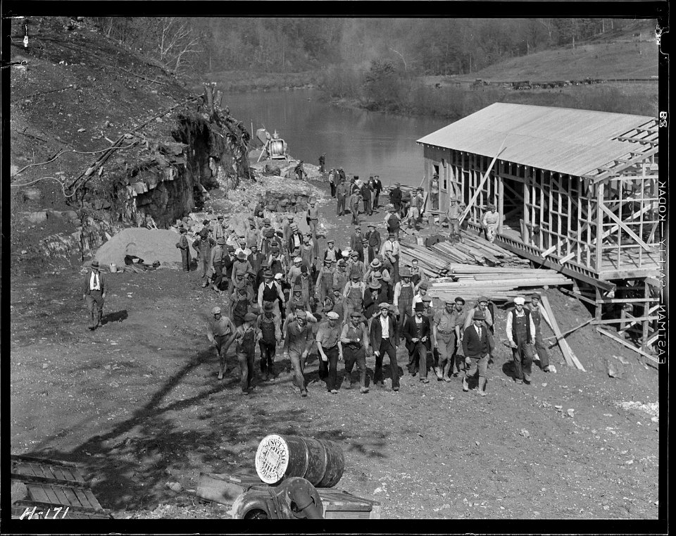 Workers returning from construction on the new bridge at Norris Dam site at noon hour. The foundations for the new... - NARA - 532788