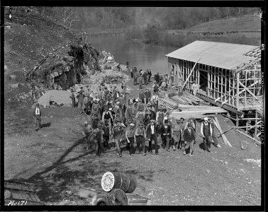 Workers returning from construction on the new bridge at Norris Dam site at noon hour. The foundations for the new... - NARA - 532788