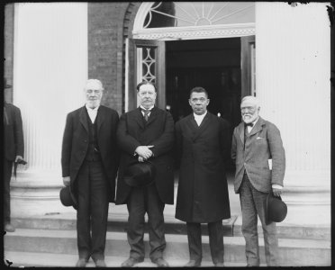 (Left to right) Robert C. Ogden, Senator William Howard Taft, Booker T. Washington and Andrew Carnegie, standing on the steps of a building, at the Tuskegee Institute's 25th anniversary LCCN2011660897 photo