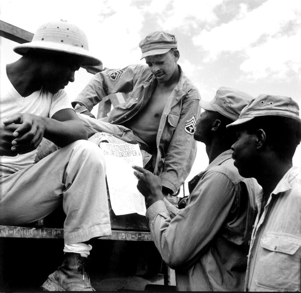 -... troops in Burma stop work briefly to read President Truman's Proclamation of Victory in Europe.-, 05-09-1945 - NARA - 531341