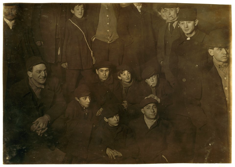 -19A Waiting for morning papers. On steps of World Building. 1 A.M. February 12,1908. Small boy in centre of group is Joseph Levite, 83 Hester Street, 13 years old. Small boy on his right LOC nclc.03170