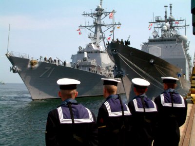 030605-O-0000K-001 Polish sailors watch as the guided missile destroyer USS Ross (DDG 71) pulls along side the guided missile cruiser USS Vella Gulf (CG 72) prior to the start of Baltops 2003 photo