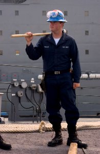 050519-N-9851B-003 - SN Walter Stewart holds a sledgehammer in preparation to release pelican hooks