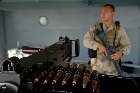 061116-N-8148A-045 PO2 Jeff Phan, attached to Mobile Security Squadron Three (MSS-3), stands a fixed post watch behind a .50-caliber machine gun, while conducting his security watch