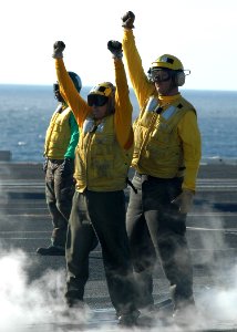 060926-N-5024R-002 - Aviation Boatwain's Mate Handling 2nd Class Ricardo Hernandez receives instructions on aircraft hand signals