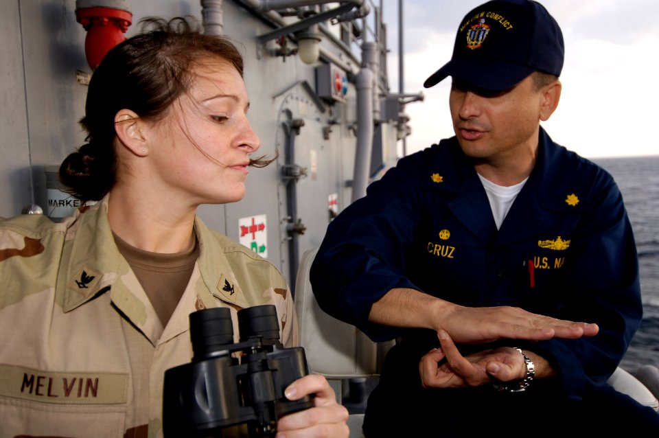 061202-N-5555T-012 USS Ardent (MCM-12) C.O. LCDR Angel Cruz speaks to PO3 Kori Melvin on Officer of the Deck procedures during a mine countermeasure exercise