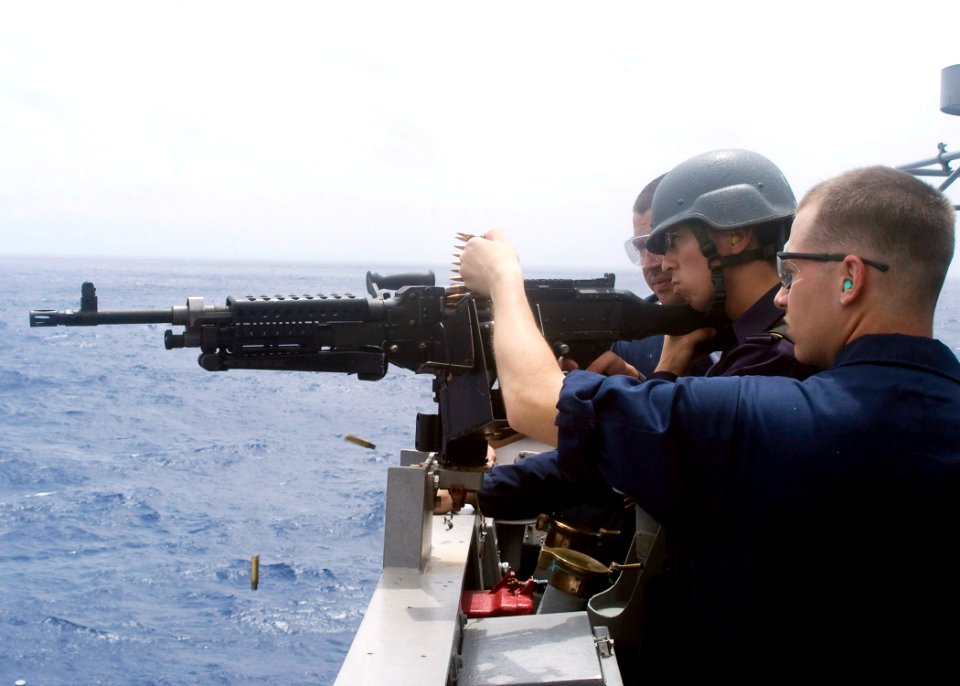 090701-N-1251W-075 - A midshipman from the Japan Maritime Self-Defense Force fires an M-240 machine gun from the bridge wing of the guided-missile cruiser USS Shiloh (CG-67)