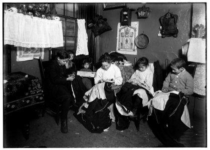1 P.M. Family of Onofrio Cottone, 7 Extra Pl., N.Y., finishing garments in a terribly run down tenement. The father works on the street. The three oldest children help the mother on LOC nclc.05508 photo