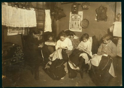 1 P.M. Family of Onofrio Cottone, 7 Extra Pl., N.Y., finishing garments in a terribly run down tenement. The father works on the street. The three oldest children help the mother on LOC nclc.05508 photo