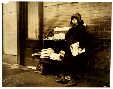 10 yr. old girl tending stand at 4th and Garden Streets. On right is entrance to bar room of saloon. Stand is owned by Mr. Rakoff, whose daughters, 11 yrs. and 13 yrs. old take turns tending LOC nclc.03826