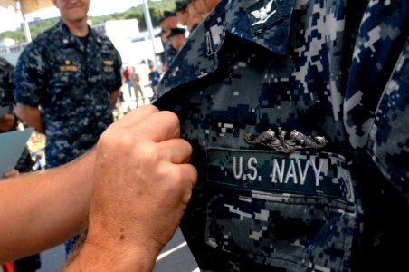 100730-N-9818V-211 MCPON Rick West pins the Enlisted Submarine Warfare pin on sailors assigned to PCU Missouri (SSN-780)