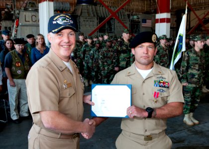 101123-N-9095H-009 CAPT K.C. Levins, commanding officer of Assault Craft Unit 4, awards Chief Hull Technician Nathanael Crossett a Bronze