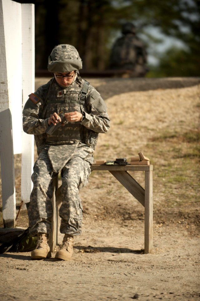 110426-N-TH989-011 - LCDR Terry McNamara, an Individual Augmentee, loads a 30-round STANAG magazine for an M16