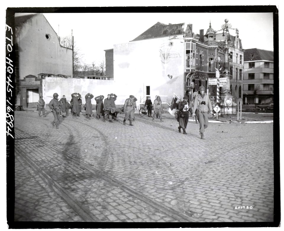 111-SC-201720 - German prisoners of war are marched into Liberated Venlo, Holland, by guards from the task force of the 35th Infantry Division