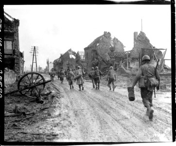 111-SC-197740 - American infantrymen move through Hurtgen, Germany, on their way to the front lines. Company I, 181st Regiment, 8th Infantry Division photo
