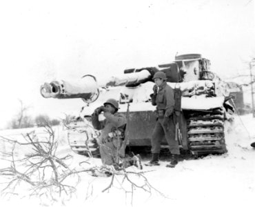 111-SC-330445 - How 81mm mortar observers work, is demonstrated by SSGT Glenn K. Keller, left, and PFC Virgil Williams, using binoculars and phone, near Oberwampach, Luxembourg. Both Men are with the 90th Infantry Division