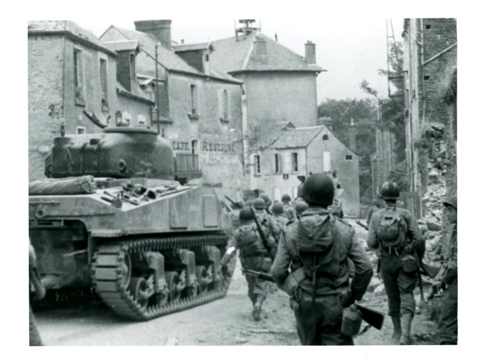 111-SC-211750-1 - Saint-Lô, France. Task force of the 29th Infantry Division meets with heavy artillery fire as it moves down the main streets to clean up what is left of the city
