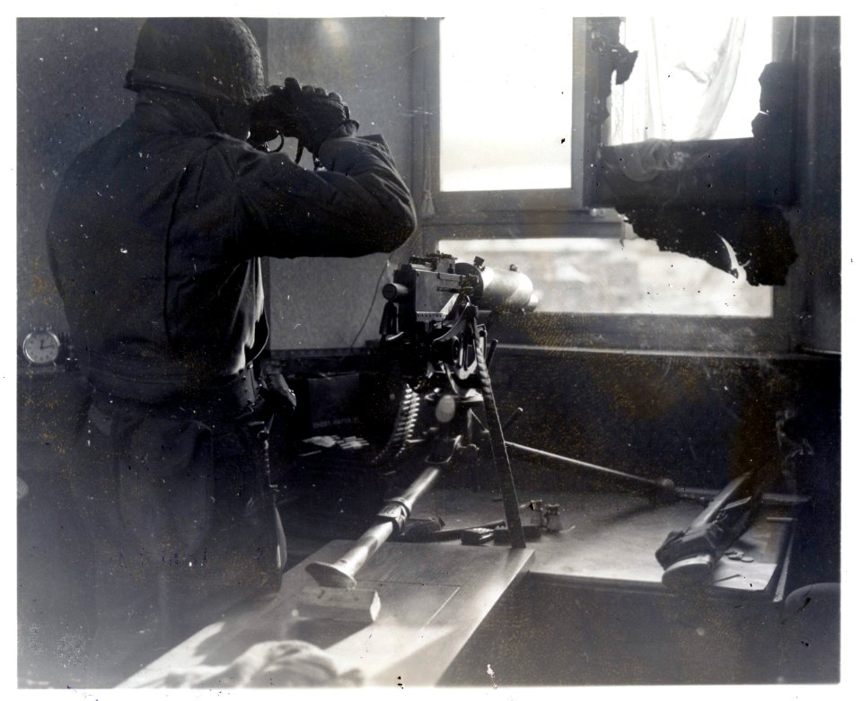 111-SC-244809-1 - Pvt. Roy McDaniels, Hartford City, Ind., keeps a look out for enemy activity from a 30th Division observation post in Stavelot, Belgium. 1st Battalion, 117th Regiment, 30th Infantry Division