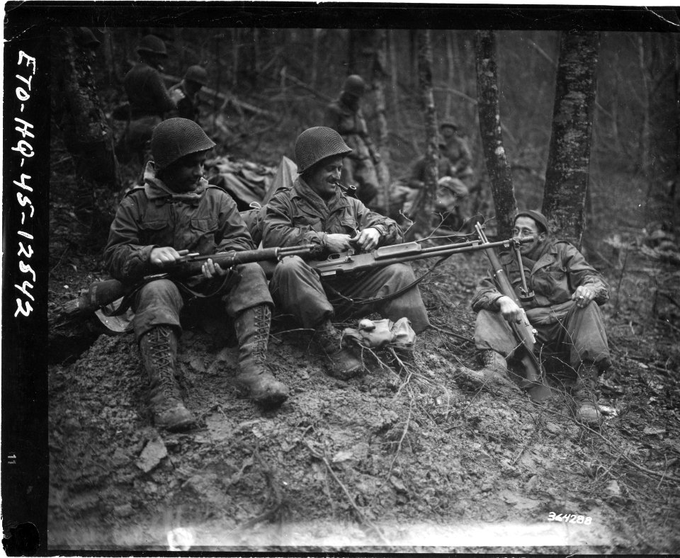 111-SC-364288 - Members of 3rd Battalion, 417th Regiment, 75th Infantry Division, clean their weapons before moving up to the line near Echternach, Luxembourg