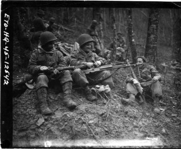 111-SC-364288 - Members of 3rd Battalion, 417th Regiment, 75th Infantry Division, clean their weapons before moving up to the line near Echternach, Luxembourg