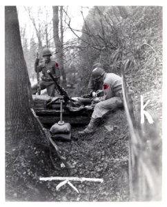 111-SC-360934 - A .50 caliber machine gun and crew are set to repel attack by advancing Germans near Malmedy, 22nd December, 1944. 120th Regiment, 30th Division