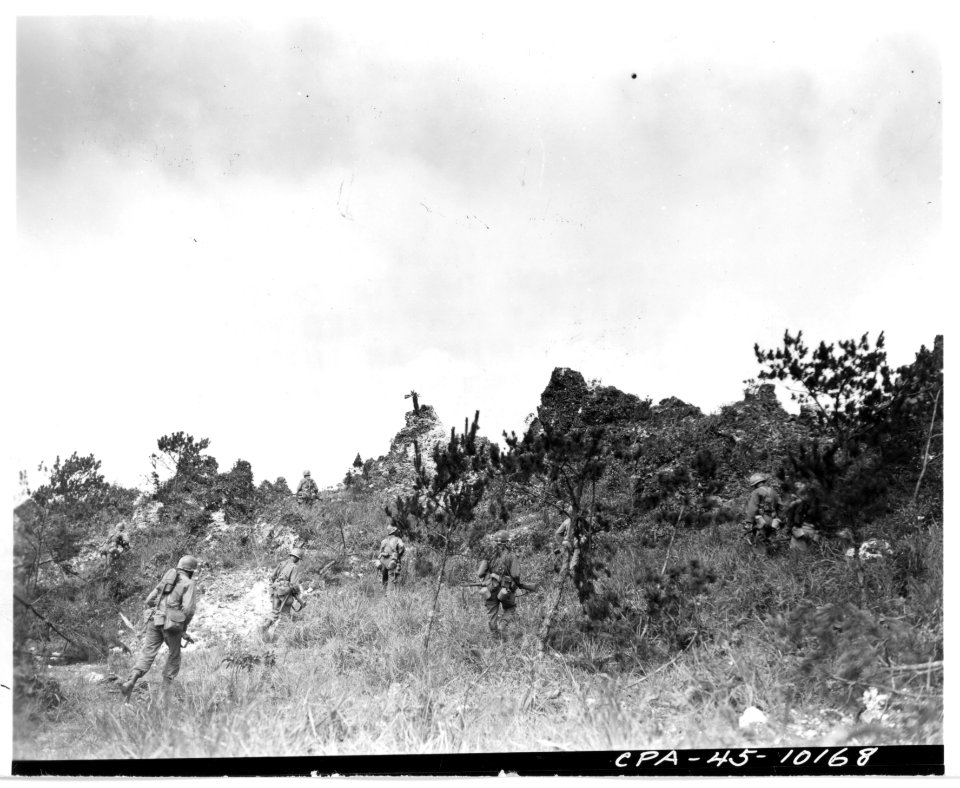 111-SC-337971 - Tenth Army doughboys of the 96th Division approach the top of Big Apple Hill, heavily fortified position, captured during an intense battle with Japanese troops on 15 June